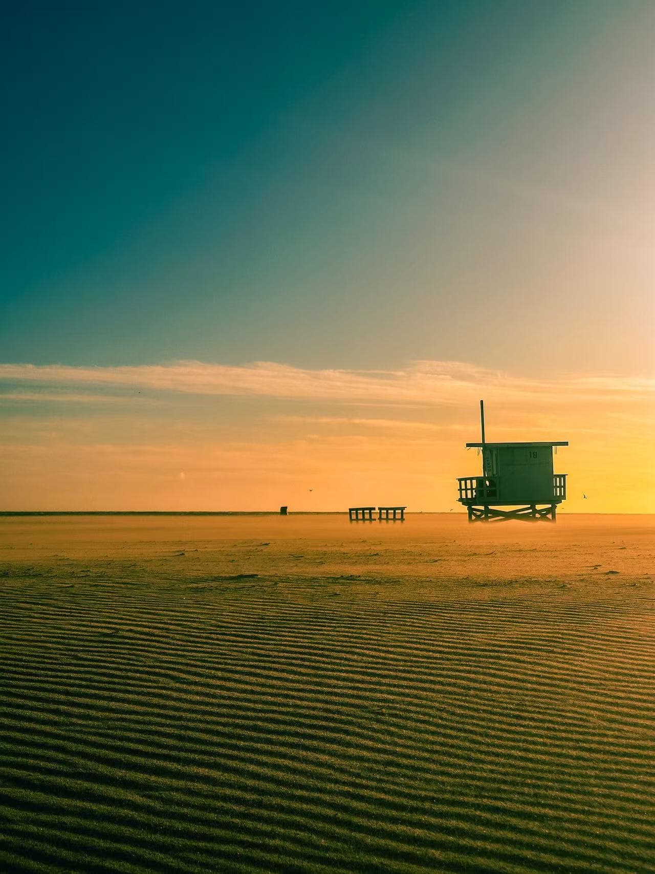 Lifeguard tower on a beach at sunset