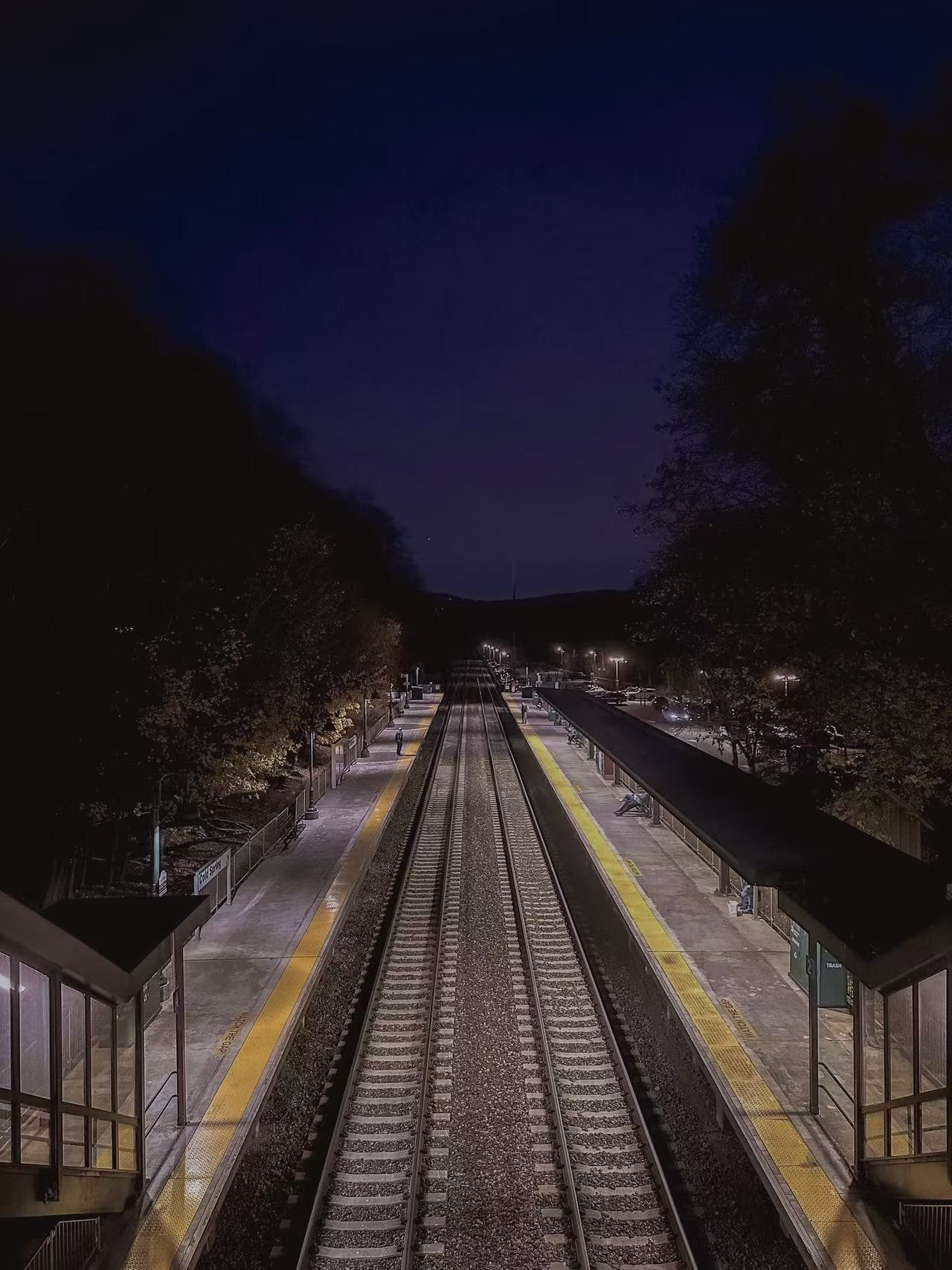 Empty train platform and tracks at night
