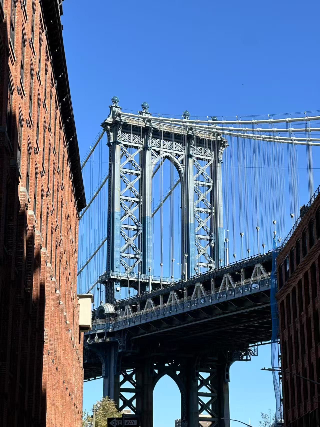 Manhattan Bridge framed between brick buildings